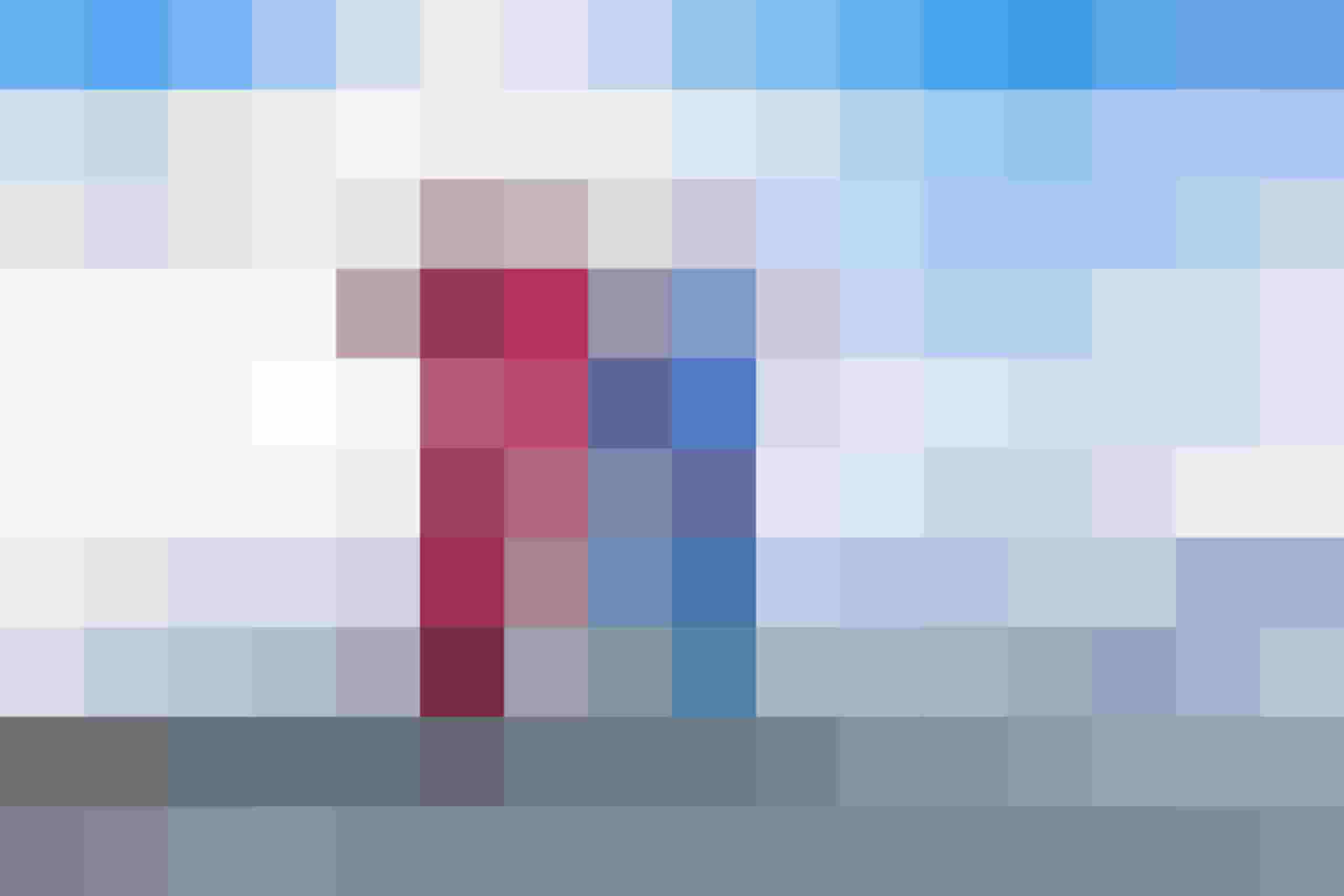 Two skiers gaze at a snow-covered Alpine landscape in the Hohe Tauern ski area.