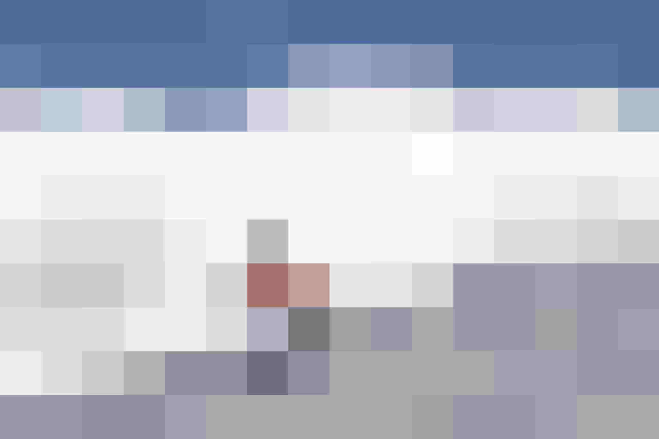 Skier in Orange on a Snow-Covered Slope with Blue Sky and Powder Snow